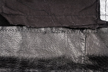 Crumpled black leather texture background. Abstract texture of messy leather with a seam. Back sideの写真素材