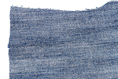 Piece of light blue jeans fabric isolated on white background. Rough uneven edges.