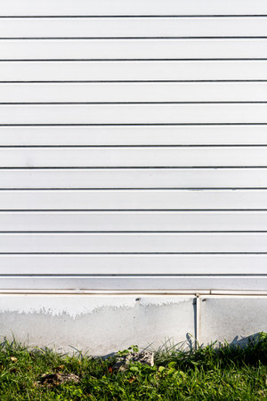 Old rusty metal warehouse wall. Architecture detail background. Metal steel texture surface of cargo wallの写真素材