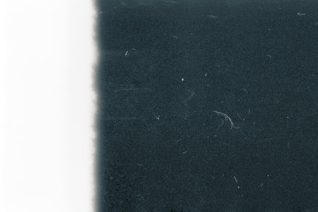 Blank grained toned film strip texture background with heavy grain and dust