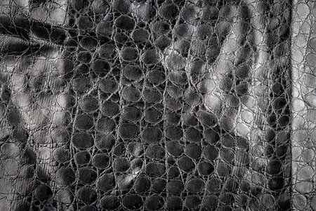 Artificial black reptile leather texture background. Fake leather texture.