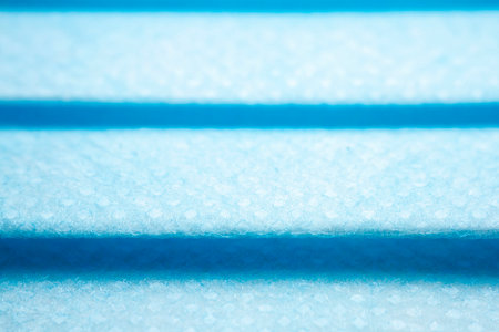 Protective, disposable light blue face mask. Extreme close-up macro photography. Selective focus.の写真素材