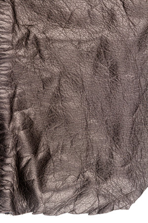Piece of brown leather isolated on white background. Crumpled material texture.