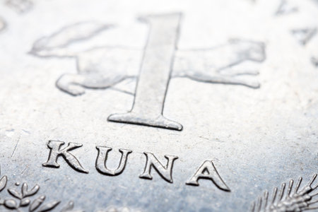 A fragment of croatian metal coin macro photo of one kuna. Selective focus.