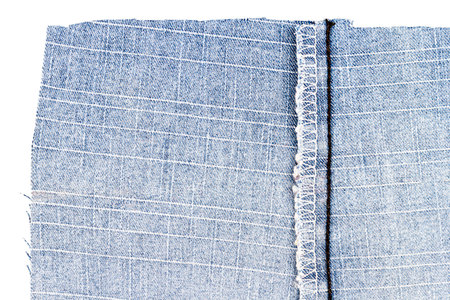 Piece of blue jeans fabric isolated on white background. Rough uneven edges. Denim pants torn. Back...