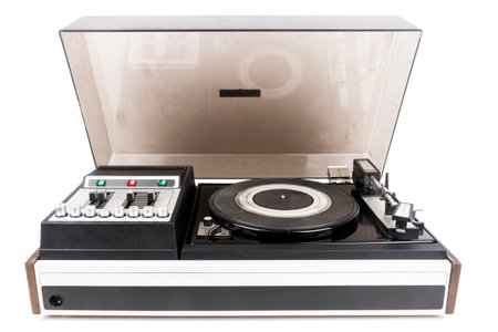 Vintage turntable vinyl record player with dust cover isolated on white background.