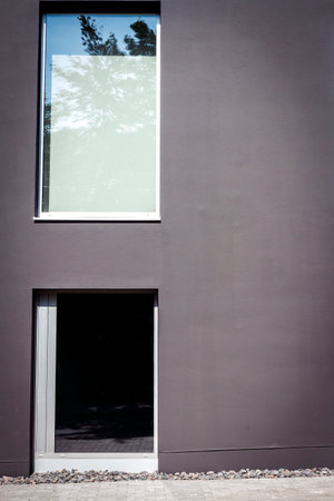 Modern black street wall with two windowsの写真素材