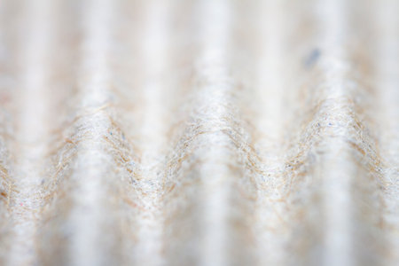 Extreme close up of beige corrugated cardboard. Selective focus.