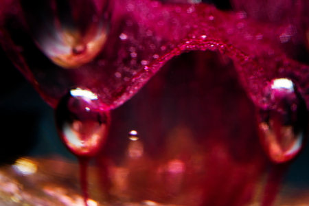 Abstract blurred photo of red blown glass. Red and black abstract background. Extreme macro.の写真素材