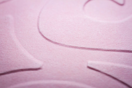 Extreme macro of embossed pink paper. Selective focus, shallow depth of field.