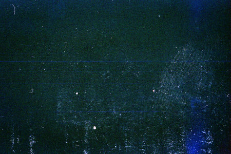 Blank grained toned film strip texture background with heavy grain, dust and light leakの写真素材