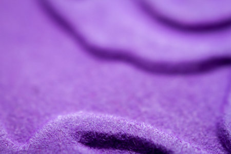 Extreme macro of embossed purple paper. Selective focus, shallow depth of field.