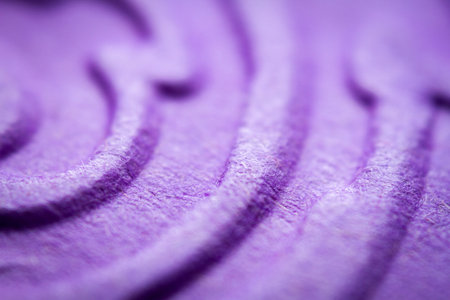 Extreme macro of embossed purple paper. Selective focus, shallow depth of field.
