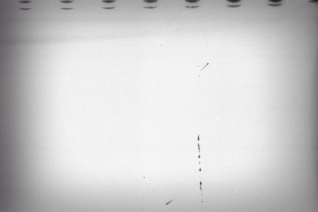 Blank grained film strip texture background with heavy grain and dustの写真素材