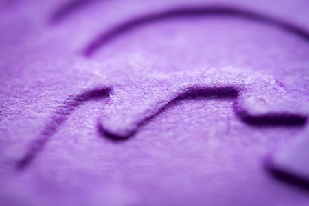 Extreme macro of embossed purple paper. Selective focus, shallow depth of field.の写真素材