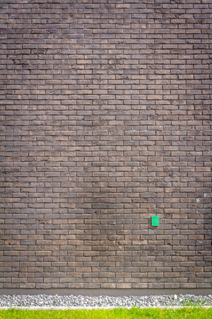 Brown brick wall background with a groundの写真素材
