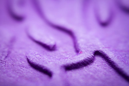 Extreme macro of embossed purple paper. Selective focus, shallow depth of field.