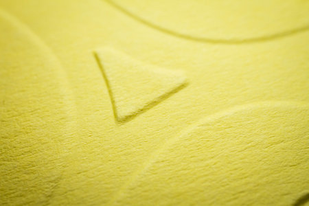 Extreme macro of embossed yellow paper. Selective focus, shallow depth of field.の写真素材