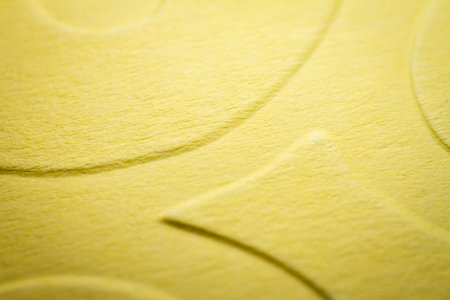 Extreme macro of embossed yellow paper. Selective focus, shallow depth of field.の写真素材