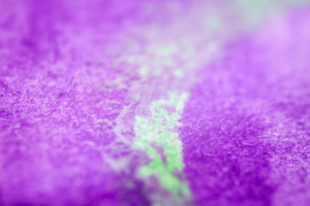 Extreme close up of purple watercolor on paper texture Selective focus. Shallow depth of field.の写真素材