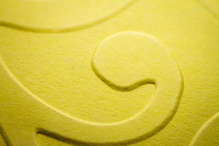 Extreme macro of embossed yellow paper. Selective focus, shallow depth of field.の写真素材