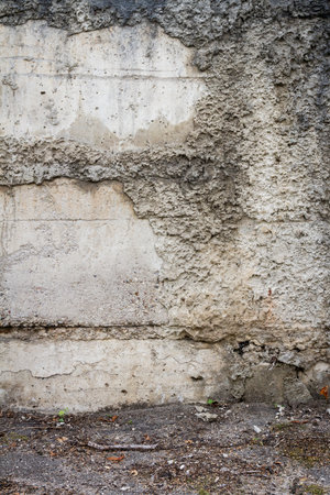 Aged weathered cracked concrete blocks wall backgroundの写真素材