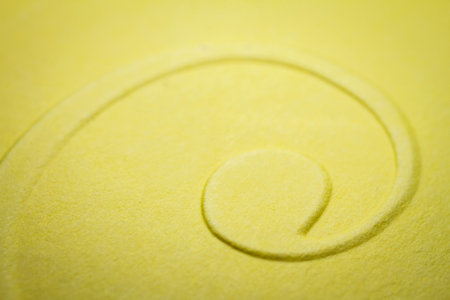 Extreme macro of embossed yellow paper. Selective focus, shallow depth of field.の写真素材