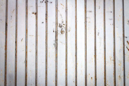 Old rusty metal warehouse wall texture background. Close up of rough metal plate. Rusty corroded...