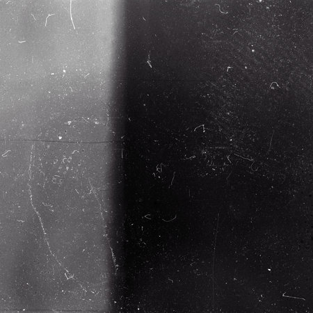 Blank grained film strip texture background with heavy grain, dust and light leakの写真素材