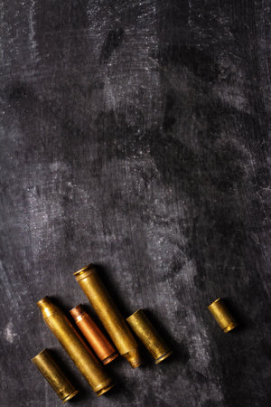 Empty bullet cartridges lying on the black background.の写真素材
