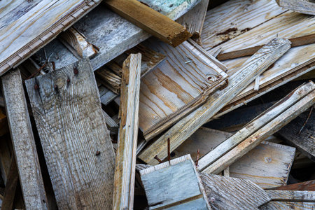 Pile of old timber wood on a backyard. Sawn old boards for firewood.の写真素材