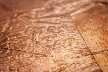 Extreme closeup of crumpled brass foil texture. Selective soft focus, shallow depth of field.の写真素材