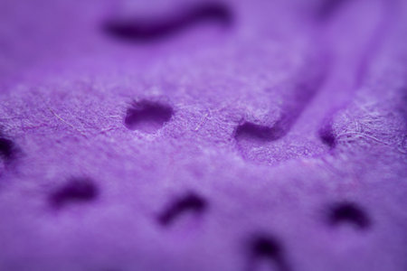 Extreme macro of embossed purple paper. Selective focus, shallow depth of field.
