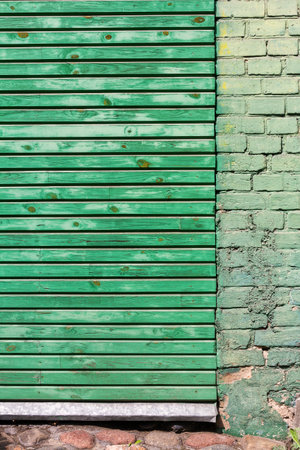 Green wooden plank and brick wall texture background.の写真素材