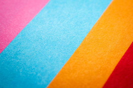 Extreme macro of multicolor background from different colors papers. Abstract colorful vibrant paper textures. Selective focus, shallow depth of field.の写真素材