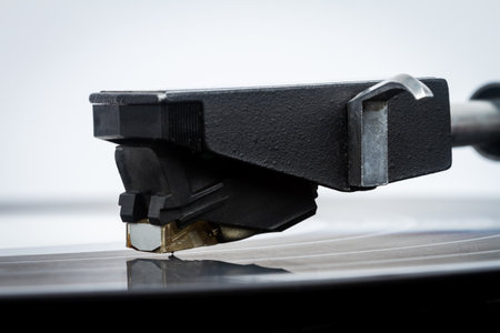 Close up of turntable needle on a vinyl record. Turntable playing vinyl. Needle on rotating black...