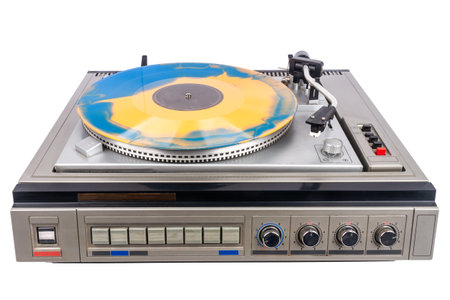 Vintage turntable record player with blue and orange vinyl isolated on white background.の写真素材