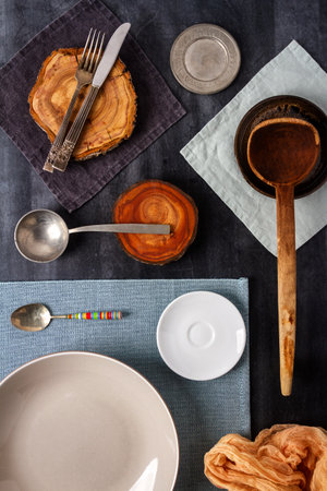 Various kitchen objects and table cloths on black chalkboard background. Flat lay. Top view.の写真素材