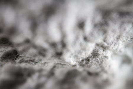 Extreme close up of old gray handmade paper clay with a structure and rough texture. Paper...