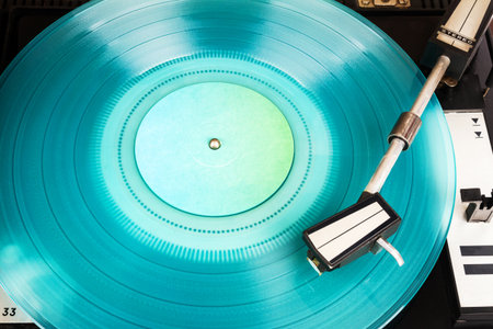 Close up of turntable needle on a vinyl record. Turntable playing vinyl. Needle on rotating...