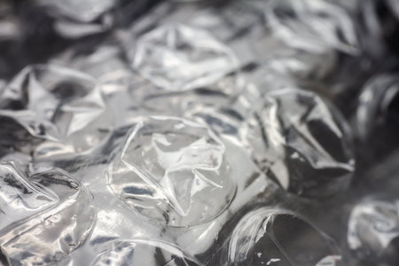 Extreme macro of plastic bubble wrap texture. Selective soft focus, shallow depth of field. Abstract dreamy backgroundの写真素材