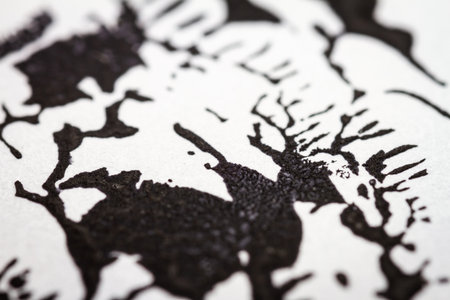 Extreme close up of black acrylic paint texture on paper. Selective focus.の写真素材