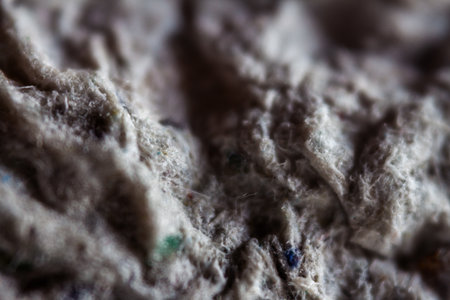 Extreme close up of old gray handmade paper clay with a structure and rough texture. Paper recycling. Selective focus, shallow depth of field.の写真素材