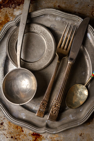 Kitchen utensils on dirty oven baking tray at kitchen, aluminum old baking sheet, top view. Grunge...