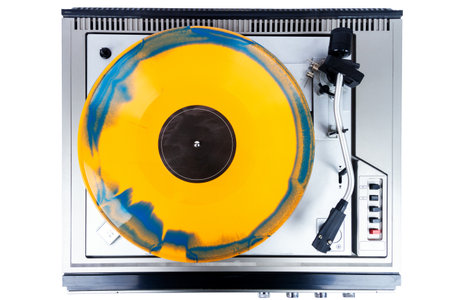 Vintage turntable record player with blue and orange vinyl isolated on white background.の写真素材