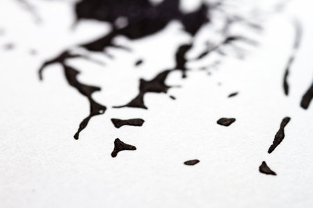 Extreme close up of black acrylic paint texture on paper. Selective focus.の写真素材