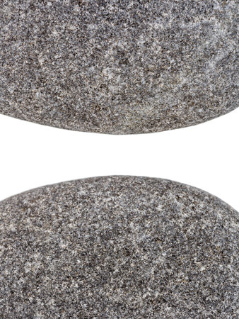 Edges of two pebbles isolated on white background with a space for textの写真素材
