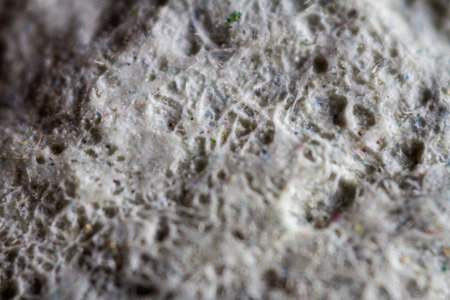 Extreme close up of old gray handmade paper clay with a structure and rough texture. Paper recycling. Selective focus, shallow depth of field.の写真素材