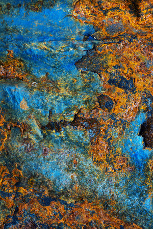 Rusty metal surface with shabby background paint. Blue cracked paint texture on an iron sheet....