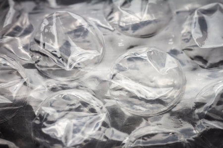 Extreme macro of plastic bubble wrap texture. Selective soft focus, shallow depth of field. Abstract dreamy backgroundの写真素材